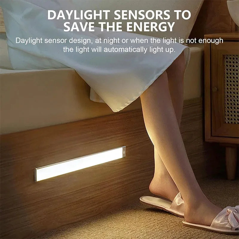 Bedroom scene with a person standing near a wooden cabinet with a built-in light, promoting daylight sensor technology.